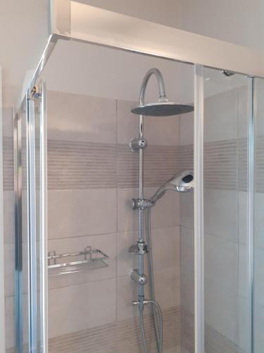a shower in a bathroom with a glass door at The view attic in Ioannina