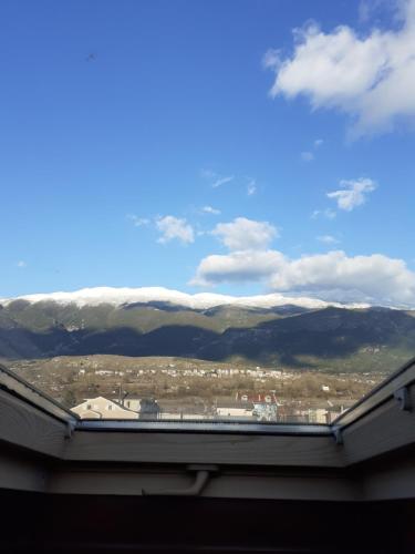 a view from the roof of a building with snow covered mountains at The view attic in Ioannina