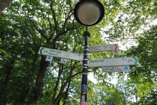 a street sign with street signs on a pole at Hotel Paulsen in Zeven