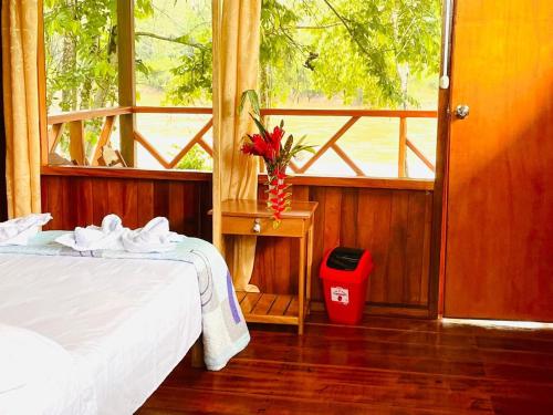 a bedroom with a bed and a window at Sunrise of Tambopata in Puerto Maldonado