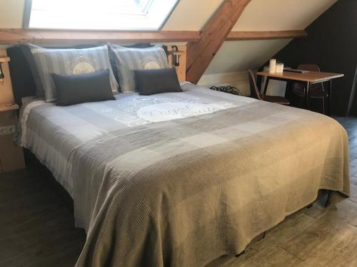 a large bed in a room with a window at De Hostee in Stolwijk