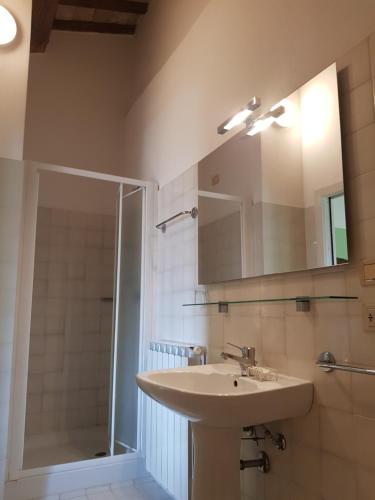 a bathroom with a sink and a shower with a mirror at Ca' le Suore in Cagli