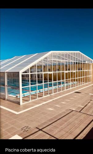 a building with a swimming pool inside of it at Residencial T2 no Parque Verde in Quinta do Conde