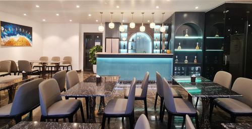 a restaurant with tables and chairs and a bar at IRIS Hotel Hải Phòng in Hai Phong