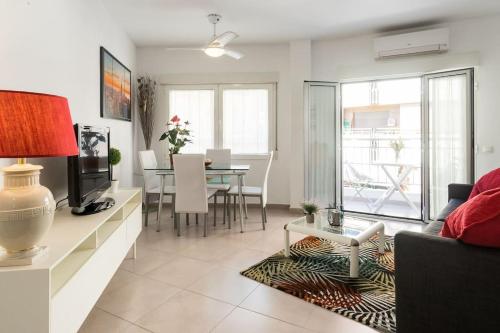 a living room with a couch and a table at Piso en primera linea de playa del Postiguet in Alicante