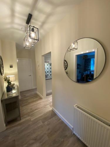a living room with a mirror on the wall at Tweed Green Holiday let in Peebles