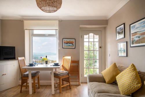 a living room with a couch and a table at Windy Ridge Terrace with beautiful sea views, North Wales Coast in Old Colwyn