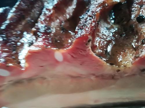 a close up of a piece of meat with sauce at Dwa Dęby in Lubawka