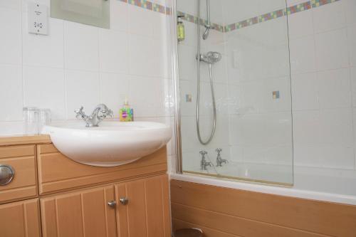 a bathroom with a sink and a shower at Craignelder Hotel in Stranraer