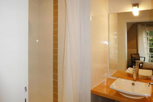 La salle de bains est pourvue d'un lavabo et d'un miroir. dans l'établissement Cottage, Carnac, à Carnac