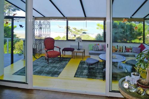 - une véranda avec 2 chaises et une table dans l'établissement Cottage in Locquirec with Beach Access, à Locquirec