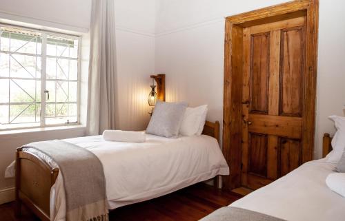 A bed or beds in a room at Rooikraal Farm Guesthouse and dam