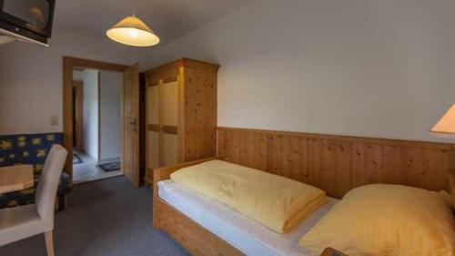 a bedroom with a large bed in a room at Pension Rieder in Alpbach