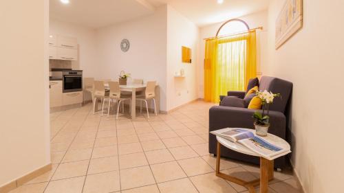 a living room with a couch and a table at Sardinianworld - Il Lentischio in Càbras