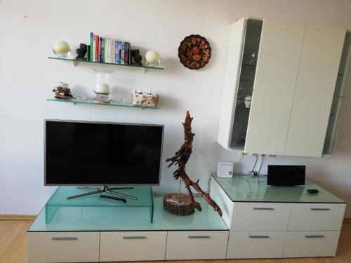 a living room with a tv on top of a cabinet at Lebensfreude Appartement in Bad Goisern