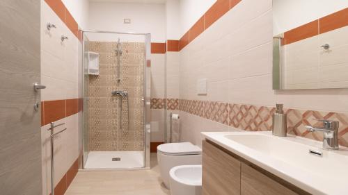 a bathroom with a shower and a toilet and a sink at Sardinianworld - Il Lentischio in Càbras
