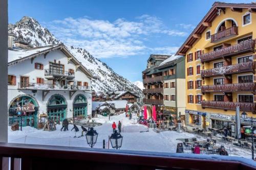 a view from a balcony of a town with snow covered buildings at 2 bed in Prince des Cimes Residence - Ski in Ski out - Arc 1950 in Bourg-Saint-Maurice
