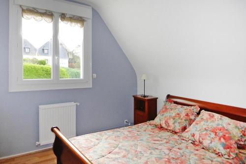 a bedroom with a bed and a window at Cottage, Perros Guirec in Saint-Quay-Perros