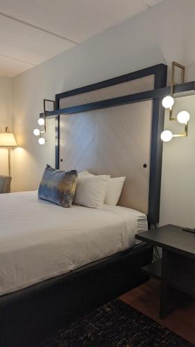 a bedroom with a large bed with a pillow on it at Hotel Indigo Jacksonville-Deerwood Park by IHG in Jacksonville