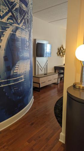 a living room with a television and a couch at Hotel Indigo Jacksonville-Deerwood Park by IHG in Jacksonville