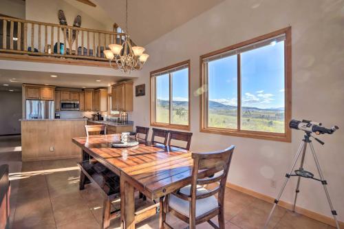 a dining room with a table and a camera on a tripod at Silverheels Ranch with Game Room, Near Breck! in Fairplay