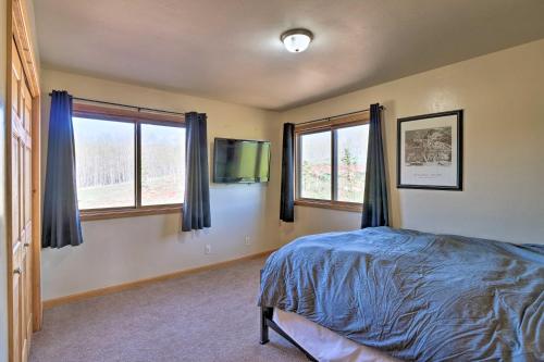 a bedroom with a bed and two windows at Silverheels Ranch with Game Room, Near Breck! in Fairplay