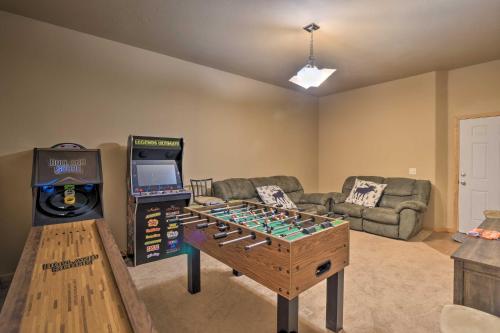 a living room with a table and a video game at Silverheels Ranch with Game Room, Near Breck! in Fairplay