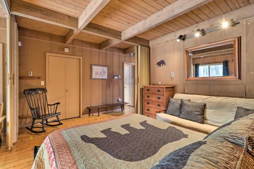 a bedroom with a large bed and a chair at Fire Pit and Grill Lakefront Poconos Cottage! in East Stroudsburg