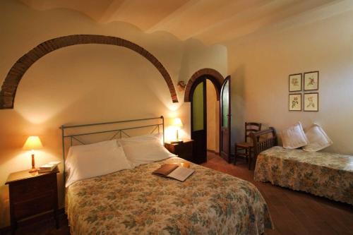 Un dormitorio con una cama con un libro. en Il Lebbio Agriresort, en Montaione