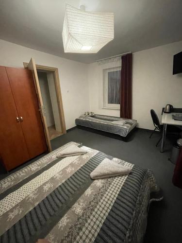 a room with two beds and a desk and a window at Antonina ***PensjonPrzyKortach*** in Szczawno-Zdrój