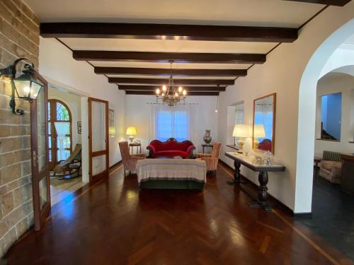 a living room with a bed and a table at Hosteria del Bosque in Necochea