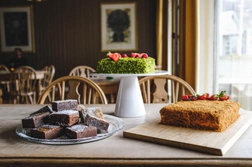 a table with two pieces of cake on a table at Snæfell - Hotel by Aldan in Seyðisfjörður