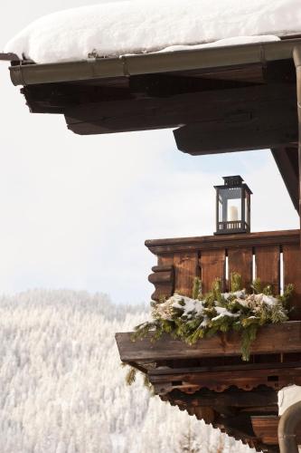 a building with snow on top of it with a view at House of Hütter - Wachtelhof & SPA in Maria Alm am Steinernen Meer
