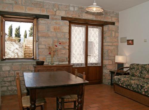 a living room with a table and a couch at Ca' le Suore in Cagli
