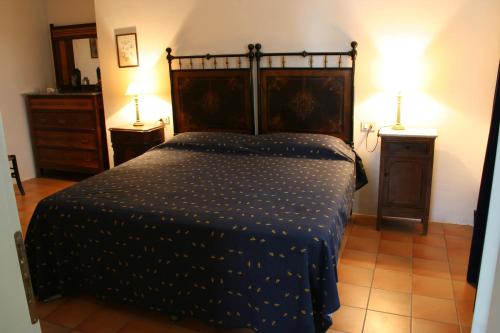 a bedroom with a bed and two night stands at Ca' le Suore in Cagli