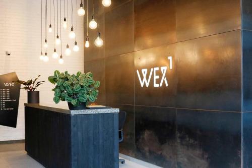 a lobby with aww sign on a wall at WEX1 Private Apartments by Perch Stays in Cape Town