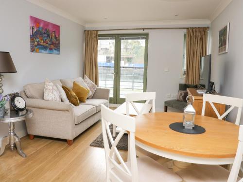 a living room with a table and a couch at Flat 2 in Pembroke