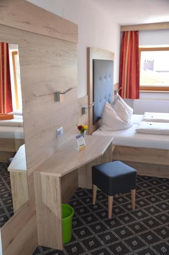 a hotel room with a bed and a desk at Gasthof Schöntal in Oberau