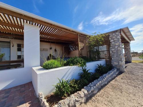 a house with plants in front of it at Oorgenoeg in Langebaan in Langebaan