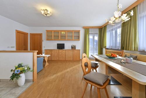 a kitchen and living room with a table and chairs at Obergasserhof in Rodengo