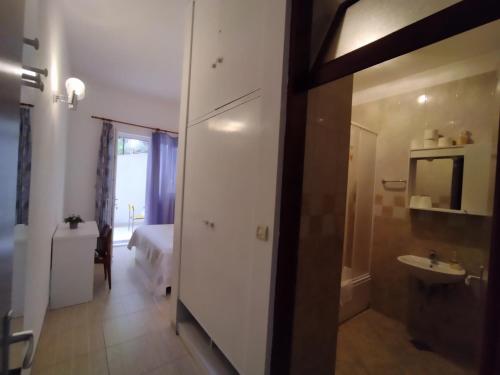 a room with a bathroom with a sink and a bed at Apartments Lalić - Two bedroom ground floor apartment close to the beach in Tučepi