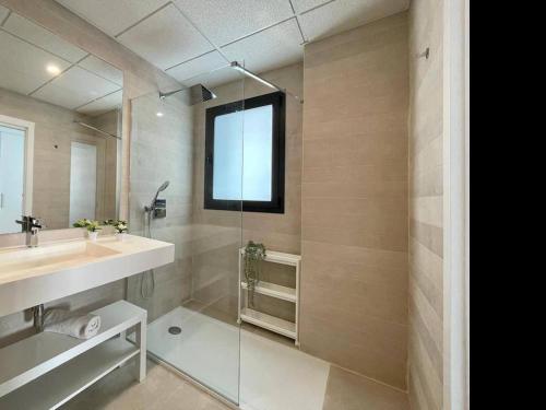 a bathroom with a sink and a shower with a mirror at Holidays2Torremolinos Alamos 3 bedroom & terrace & pool in Torremolinos