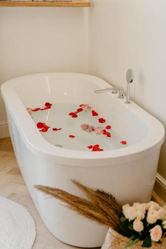 a white bath tub with flowers on it in a bathroom at Hotel Abaco Altea in Altea