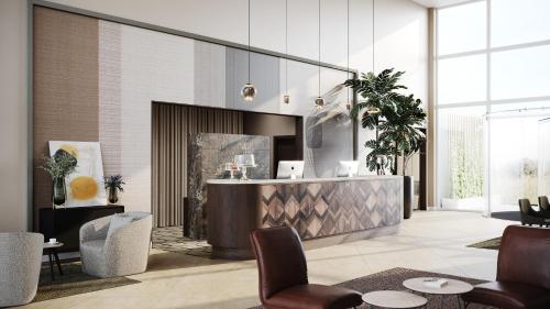 a lobby with a reception desk and chairs at Hotel de Schelde in Cadzand-Bad