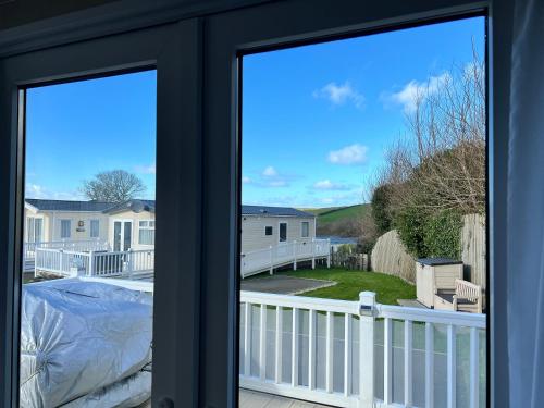 a view from the front door of a house at Mollys Retreat pet friendly three bed caravan with small garden Newquay Bay Resort Quieter area of park in Newquay