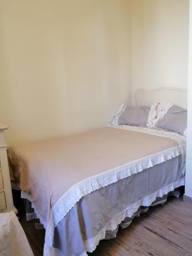 a bedroom with a bed with a white bedspread at Casale Cisanello in Pisa