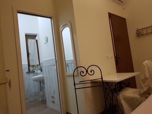 a small bathroom with a sink and a mirror at Casale Cisanello in Pisa