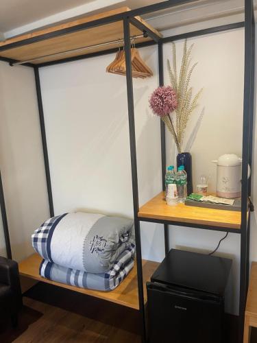 a room with a bunk bed and a shelf at River Hotel in Chiayi City