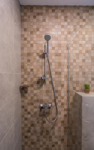 a shower with a glass door in a bathroom at New Gudauri Alpic 406 in Gudauri