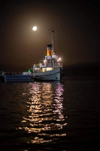 a boat sitting in the water at night at Dardanelles1915 in Canakkale